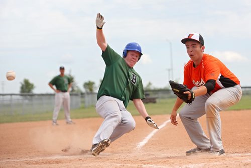 Brandon Sun 12012013 Graham Wright #39 of the Brandon Green Sox slides safely into home plate as the ball is thrown to Jeremy Roe #16 of the Binscarth Orioles during the Bantam AProvincial Championships at Simplot Millennium Park on Friday. (Tim Smith/Brandon Sun)