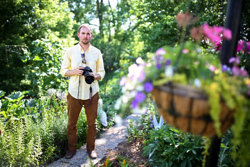 Brandon Sun 12012013 Artist Kevin Bertram poses for a portrait while taking photographs of flowers in the backyard garden of a home on the north hill in Brandon on Friday evening. (Tim Smith/Brandon Sun)