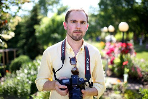 Brandon Sun 12012013 Artist Kevin Bertram poses for a portrait while taking photographs of flowers in the backyard garden of a home on the north hill in Brandon on Friday evening. (Tim Smith/Brandon Sun)