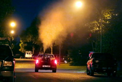 Brandon Sun A city fogging truck makes a sweep through a residential neighbourhood in the southwest section of the city on Tuesday evening. (Bruce Bumstead/Brandon Sun)