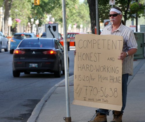 Unemployed worker Tim Candy who is looking for work wore this sign to flag early morning commuters on Sherbrook St    Candy was on Workers Compensation after cutting off one of his fingers with a circular saw two years ago and now needs work- Standup photo- July 17, 2013   (JOE BRYKSA / WINNIPEG FREE PRESS)