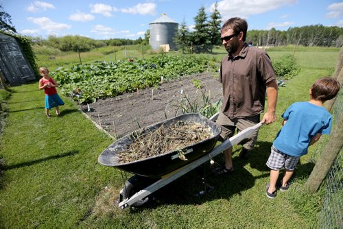 Hannah, Trevor, Adrienne and Noah working in the garden. Adrienne and Trevor Percy, their son Noah, 9 and daughter Hannah, 6, live at Nourished Roots, their homestead north of Teulon, Tuesday, July 16, 2013. (TREVOR HAGAN/WINNIPEG FREE PRESS) - for alex paul story