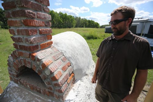 Trevor with the newly built cob oven. Adrienne and Trevor Percy, their son Noah, 9 and daughter Hannah, 6, live at Nourished Roots, their homestead north of Teulon, Tuesday, July 16, 2013. (TREVOR HAGAN/WINNIPEG FREE PRESS) - for alex paul story