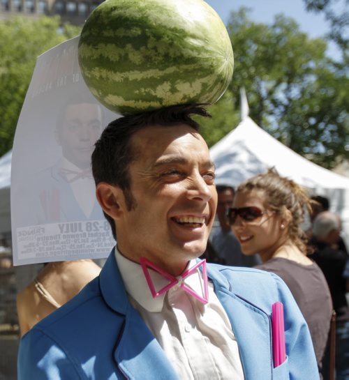 Performer Daniel Oldaker, balancing a watermelon on his head, was at the Old Market Square for the official kickoff of the Winnipeg Fringe Festival. The square was chock full of music, dancing and colourful characters. You can catch his show, Dandyman, from July 17-27. Wednesday, July 17, 2013. (JESSICA BURTNICK/WINNIPEG FREE PRESS)