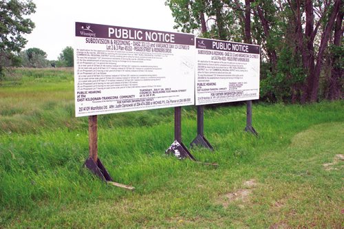 Canstar Community News July 12, 2013 - Signs for the public hearing regarding the Shops of Kildonan Mile development on July 16, 2013 are shown. (DAN FALLOON/CANSTAR COMMUNITY NEWS)
