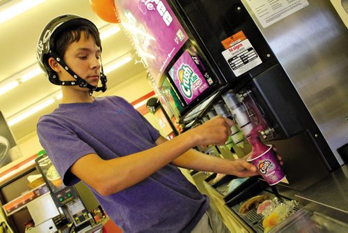 Canstar Community News July 17, 2013 --  Daniel Desousa, 16, pours himself a free Slurpee at the 7-Eleven at 1200 Jefferso Ave. on July 11. Manitoba was named Slurpee Capital of the World for the 14th consecutive year. MATT PREPROST/CANSTAR COMMUNITY NEWS