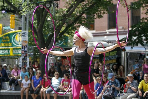 Fringe Festival performer Lisa Lottie from the Netherlands performs a gymnastics routine using hula hoops for a large audience at Old Market Square on Thursday, July 18, 2013. (JESSICA BURTNICK/WINNIPEG FREE PRESS)
