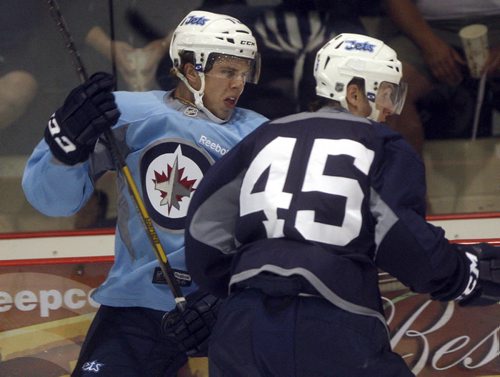 Wpg Jets development camp at MTS Iceplex -Forward  #72 Scott Kosmachuk takes bump  during scrimage from #45 Jimmy Lodge - for tim campbell  story  KEN GIGLIOTTI / JULY 19 2013 / WINNIPEG FREE PRESS