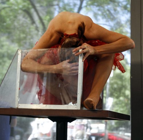 Fringe perform and contortionist Rani Huszar fits herself into a box at the Winnipeg Free Press News Cafe during live interview with reporter Elizabeth Fraser on Friday, July 19, 2013. You can catch her show during the Winnipeg Fringe Festival until July 27. (JESSICA BURTNICK/WINNIPEG FREE PRESS)
