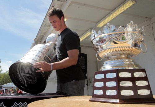 Chicago Blackhawks captain Jonathan Toews with the Stanley Cup and the Frank J. Selke Trophy - Best Defensive Forward he won and brought to Winnipeg for the hundreds of fans to see that attended the event at the Jonathan Toews Community Centre Friday afternoon. Randy Turner story Wayne Glowacki/Winnipeg Free Press July 19 2013