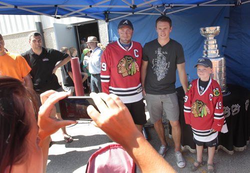Jody Conrad and his son Nathan, 8, made the 2.5 hour drive from Mariapolis, MB. to meet Chicago Blackhawks Captain Jonathan Toews at the event outside the Jonathan Toews Community Centre Friday afternoon.   Randy Turner story Wayne Glowacki/Winnipeg Free Press July 19 2013