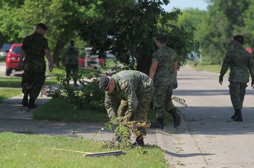 Brandon Sun Soldiers with the 1 Royal Canadian Horse Artillery work to remove the debris for the residences at CFB Shilo on Friday morning following a sever thunder storm that ripped through Westman on Thursday evening. (Bruce Bumstead/Brandon Sun)