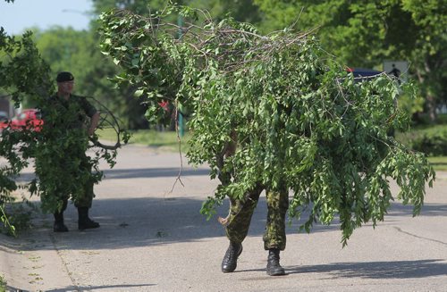 Brandon Sun Soldiers with the 1 Royal Canadian Horse Artillery work to remove the debris for the residences at CFB Shilo on Friday morning following a sever thunder storm that ripped through Westman on Thursday evening. (Bruce Bumstead/Brandon Sun)