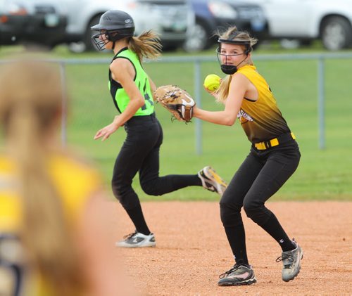 Brandon Sun Westman Magic's Hailey Curtis aims and fires the ball to first base for the out against the Wild during Friday's girl fastball tournament. (Bruce Bumstead/Brandon Sun)