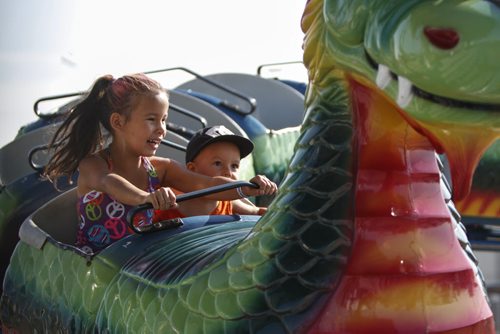 Siblings Gabriel Daniels, 6, and Akwatin, 2, of Saskatoon take a wild ride atop a dragon roller coaster at the midway of the Manitoba Stampede and Exhibition, which celebrates its 50th year this weekend. Friday, July 19, 2013. (JESSICA BURTNICK/WINNIPEG FREE PRESS)
