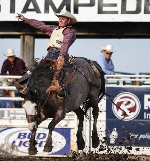 Saddlebronc competitor Mark O'Dempsey of Mayerthorpe, Alta. takes a wild ride atop Red Rodeo at the Manitoba Stampede and Exhibition as it celebrates its 50th year this weekend. Friday, July 19, 2013. (JESSICA BURTNICK/WINNIPEG FREE PRESS)