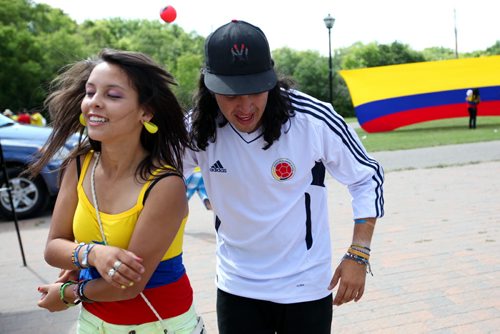 Brandon Sun 20072013 Jonathan Aguirre and Paula Aguirre dance the Salsa during Colombian Independence Day celebration's at the First Street spray park on Saturday afternoon. Brandon's Colombian community gathered for games, a barbecue, dancing and other events.  (Tim Smith/Brandon Sun)