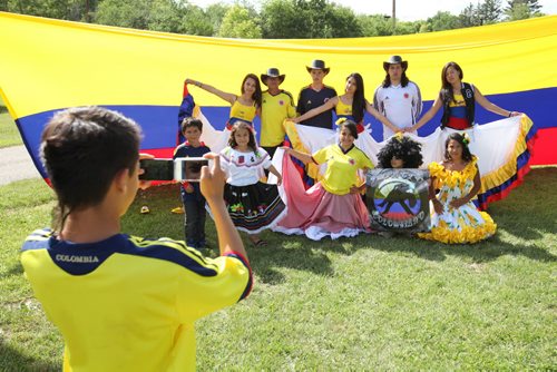 Brandon Sun 20072013 Members of the dance group Colombian Impact pose for a photo during Colombian Independence Day celebration's at the First Street spray park on Saturday afternoon.  (Tim Smith/Brandon Sun)