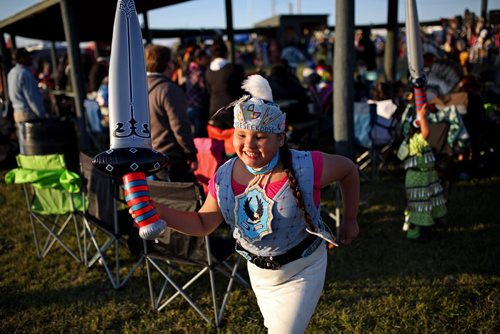 Brandon Sun 20072013 Lilyanna Quewezance of Keeseekoose First Nation in Saskatchewan plays with friends during the Rolling River First Nation Pow Wow on Saturday evening. (Tim Smith/Brandon Sun)