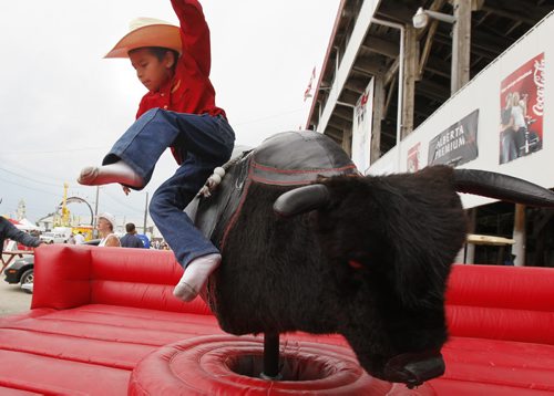 July 21, 2013 - 130721  -  Cole Patrick (6), who was in the final of Mutton Bustin' competition, rides a mechanical bucking bull at the Morris Stampede Sunday, July 21, 2013. John Woods / Winnipeg Free Press