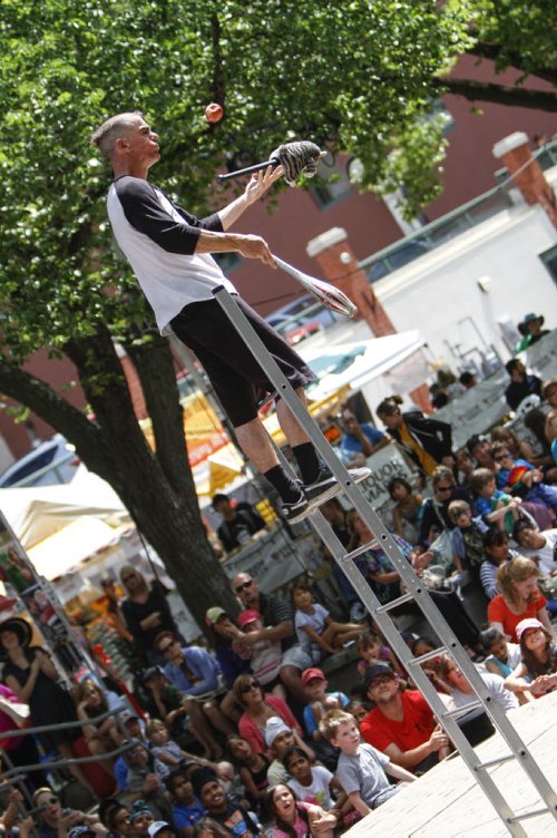 David Ladderman takes his Winnipeg Fringe Festival antics up a notch from atop a ladder in Old Market Square, delighting the large crowd gathered on Tuesday, July 23, 2013. (JESSICA BURTNICK/WINNIPEG FREE PRESS)