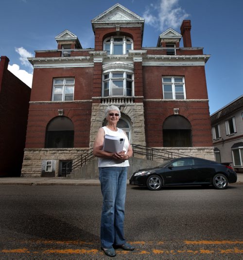 Carberry "Heritage" spokeswoman Penny Shaw poses in front of her favorite Main Street building, an empty turn of the century Bank. See Bill Redekop's story. July 23, 2013 - (Phil Hossack / Winnipeg Free Press)