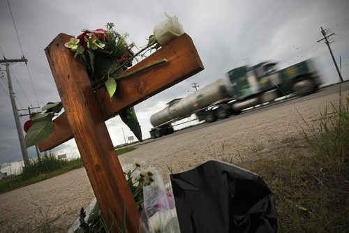 On Tuesday, July 23, 2013 a memorial has been set up in Headingley for Derek Bossuyt who was killed when a semi crossed into his lane Monday night.  (John Woods/Winnipeg Free Press)