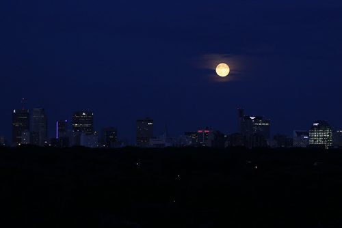 The moon rises over Winnipeg skyline Tuesday, July 23, 2013.  (John Woods/Winnipeg Free Press)