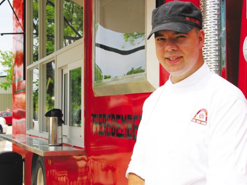 Canstar Community News July 17, 2013 - Owner Steffen Zinn, of Starbuck, offers freshly made and baked pizzas from his Red Ember food truck. (ANDREA GEARY/CANSTAR)