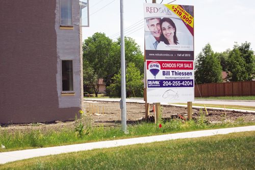 Canstar Community News July 18, 2013 - A sign advertises the first phase of the Red Oak Condos. Developer Karl Devlin of Carrington Homes says City of Winnipeg fees for street improvements may affect the planned second phase. (DAN FALLOON/CANSTAR COMMUNITY NEWS)