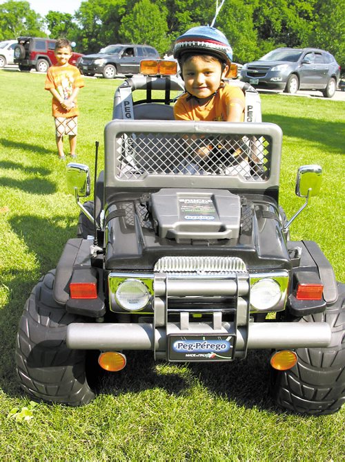 Canstar Community News July 24, 2013 -- Isaiah, 3, drives his new jeep that was presented by The Dream Factory at St.Vital Park on July 19.
