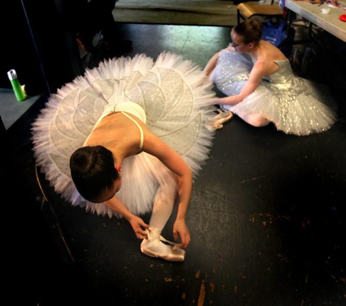 Last minute adjustments, aspiring ballerina's with the RWB School tie up last minute details before assuming the stage at The Lyric Theater in Assinaboine Park Wednesday evening for Ballet in the Park. See release....the annual perfomances wrap up July 26. July 24, 2013 - (Phil Hossack / Winnipeg Free Press)