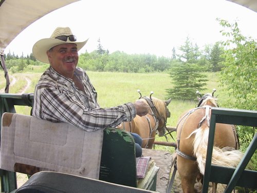 Bill Redekop photo / story Winnipeg Free Press about grizzled cowboy who has gives tours of the sand hills, and about the virtual disappearance of those sand hills. Larry Robinson of Spirit Sands Wagon Outfitters, has been giving horse-drawn wagon tours of the sand hills for almost two decades. July 22 2013.