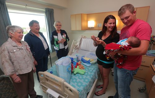 Brandon Sun Parents Teagan and Troy Kliever were delighted to receive a gift bag for their son, Cruz, from Olga McIntyre, Heather Moore and Lorna Cowan, members of the IODE, on Thursday afternoon at the Brandon Regional Health Centre. Baby Cruz was born closest to the time to that of the Royal baby, Prince George of Cambridge. Cruz is the latest addition to the Kliever family and was going home to Souris to meet his older brother Paysen on Thursday. (Bruce Bumstead/Brandon Sun)