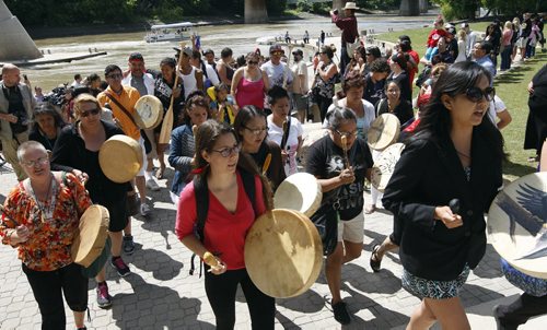 A large group of drummers were at the Forks to greet them and lead them from the dock-Fourteen paddlers from  the Pimicikamak  Cree First Nation  arrived at the Forks after a grueling 19 day 890 km trip  the  Ininiwi Aski Quest advocates for the protection of Lake Winnipeg . KEN GIGLIOTTI / JULY 26 2013 / WINNIPEG FREE PRESS