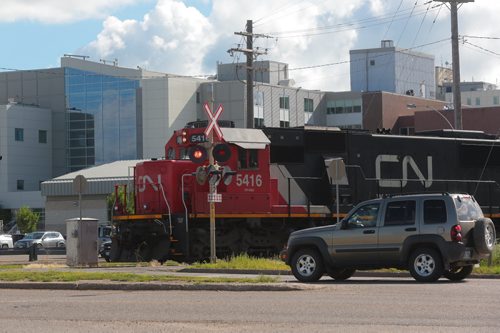 Brandon Sun A CN Rail locomotive approaches a level crossing at First Street near the Brandon Regional Health Centre on Friday morning. (Bruce Bumstead/Brandon Sun)