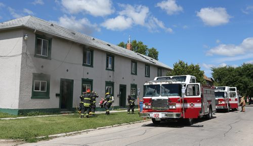 Firefighters arrive at a fire inside a two storey apartment building at the corner of Stella and Powers, Saturday, July 27, 2013. (TREVOR HAGAN/WINNIPEG FREE PRESS)