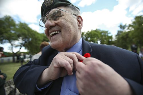 Retired army veteran and captain Brian Koshul puts a poppy on the lapel of his jacket. A candle light service was held in Brookside Cemetery by the Korea Veterans Association on Saturday, July 27, 2013 to mark the 60th anniversary of the Korean War ceasefire. The service also recognized the designation of 2013 as The Year of the Korea War Veteran by the Canadian government. Five hundred and sixteen Canadians gave their lives in the Korean War, which lasted three years and ended on July 27, 1953.  (MARY AGNES WELCH) (JESSICA BURTNICK/WINNIPEG FREE PRESS)