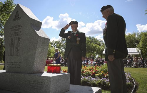 A war veteran salutes the Korea War memorial monument at Brookside Cemetery. A candle light service was held by the Korea Veterans Association on Saturday, July 27, 2013 to mark the 60th anniversary of the Korean War ceasefire. The service also recognized the designation of 2013 as The Year of the Korea War Veteran by the Canadian government. Five hundred and sixteen Canadians gave their lives in the Korean War, which lasted three years and ended on July 27, 1953.  (MARY AGNES WELCH) (JESSICA BURTNICK/WINNIPEG FREE PRESS)
