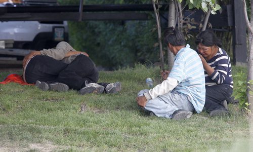 Four people hanging out under some trees near Walmart in Thompson, Monday, July 22, 2013. (TREVOR HAGAN/WINNIPEG FREE PRESS)