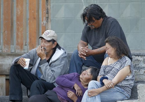 Four people sitting on steps on Churchill Drive in Thompson, Monday, July 22, 2013. (TREVOR HAGAN/WINNIPEG FREE PRESS)