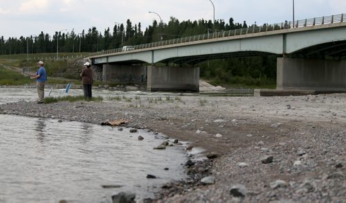 Mike and Regina Gibbons fishing on the Burntwood River in front of the Miles Hart Bridge in Thompson, Monday, July 22, 2013. (TREVOR HAGAN/WINNIPEG FREE PRESS)