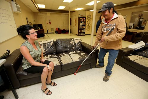Paullette Simkins, Executive Director of the Thompson Homeless Shelter, speaking with a shelter client, John George, Monday, July 22, 2013. (TREVOR HAGAN/WINNIPEG FREE PRESS)