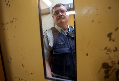 Ret. Const. Bob Gass through the window of one of the cells inside the Public Safety Building in Thompson, Monday, July 22, 2013. (TREVOR HAGAN/WINNIPEG FREE PRESS)