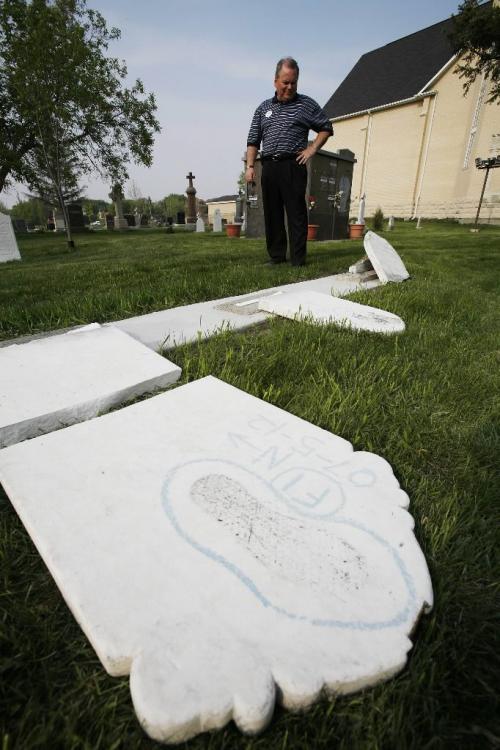 John Woods / Winnipeg Free Press / May 12/07- 070512  - Grant Nordman, city councillor for St Charles ward, inspects some vandalized gravestones at St Charles Church Saturday May 12/07.