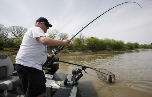 John Woods / Winnipeg Free Press / May 12/07- 070512  - Wayne Gee christens his new boat by pulling in a big 32inch catfish on the opening day of fishing season at Lockport Saturday May 12/07.   Gee's hook wasn't even in the water 5 minutes before he hooked this one.
