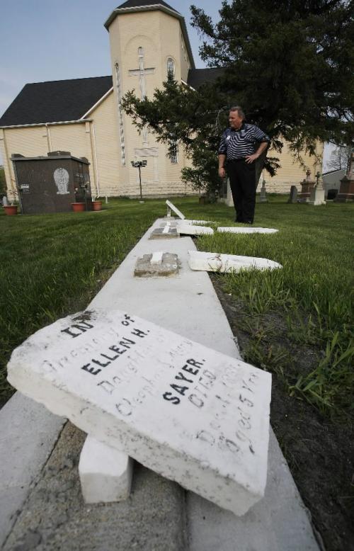 John Woods / Winnipeg Free Press / May 12/07- 070512  - Grant Nordman, city councillor for St Charles ward, inspects some vandalized gravestones at St Charles Church Saturday May 12/07.