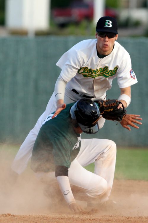 Brandon Sun 28072013 Garrett Popplestone #10 of the Brandon Cloverleafs is taken out by Ryan Cooper #4 of the Neepawa Farmers as Cooper slides into second base during MSBL semifinal playoff action at Andrews Field on Sunday evening. (Tim Smith/Brandon Sun)