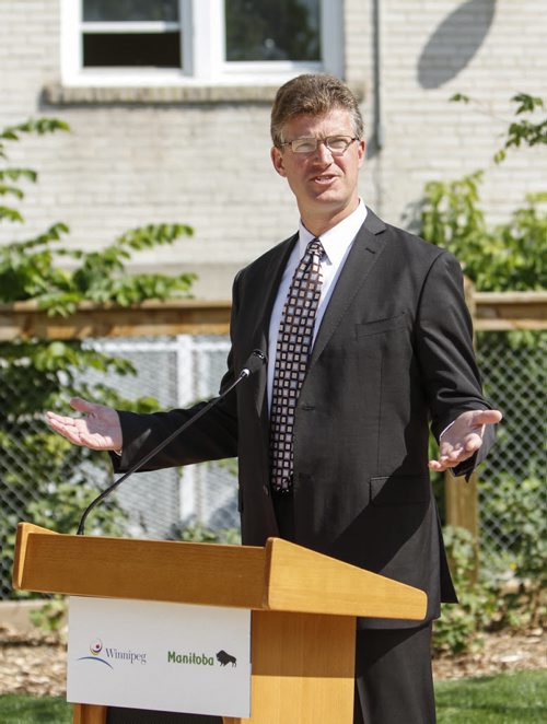 Families and residents of two inner-city neighbourhoods now have access to two newly redeveloped parks in Winnipeg; Chief Grizzly Bear's Garden (formerly known as Spence Aboriginal Spirit Park) on Sherbrooke St. at Sargent, and Jacob Penner Park on Victor Ave. at Notre Dame. The announcement was made from the Sherbrooke location by Justice Minister Andrew Swan (pictured) and Mayor Sam Katz. Joint funding in the amount of $475,000 was provided by the province and the city through the Building Communities Initiative. Tuesday, July 30, 2013. (JESSICA BURTNICK/WINNIPEG FREE PRESS)