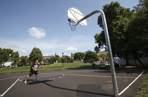 Gailard Gonzales (left) shoots some hoops with brother Julius as the newly redeveloped Jacon Penner Park on Victor Ave. at Notre Dame. The announcement that this and another park, Chief Grizzly Bear's Garden on Sherbrooke St. (formerly known as Spence Aboriginal Spirit Park), are now available to inner city families and residents was made from the Sherbrooke location by Justice Minister Andrew Swan and Mayor Sam Katz. Joint funding in the amount of $475,000 was provided by the province and the city through the Building Communities Initiative. Tuesday, July 30, 2013. (JESSICA BURTNICK/WINNIPEG FREE PRESS)